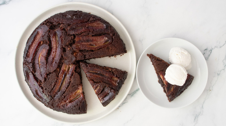 Bananas Foster brownie with slices removed next to slice on plate with ice cream