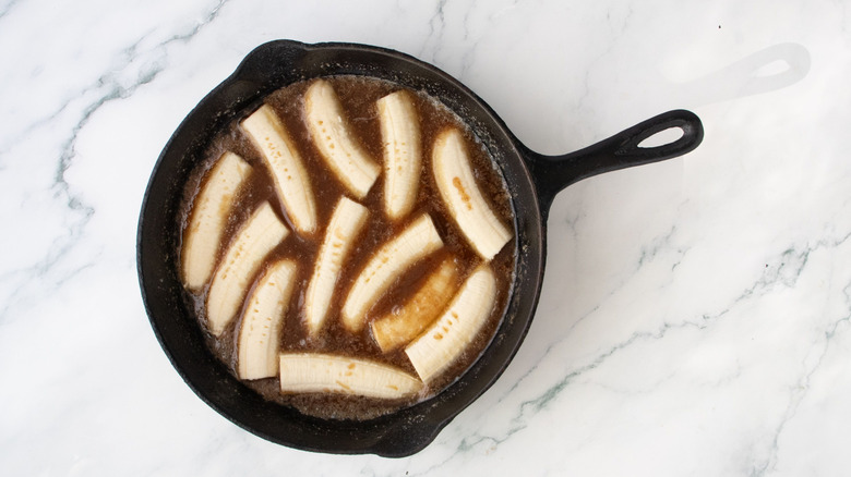Banana slices and sauce in skillet
