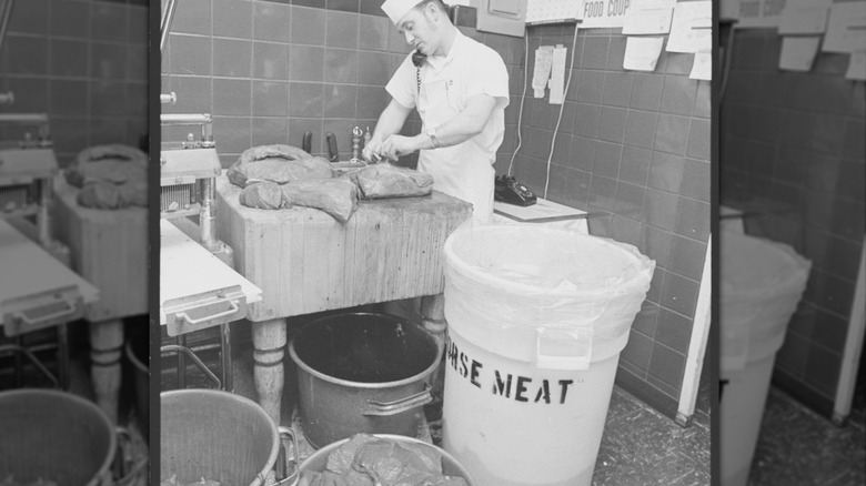 Man on telephone butchers horse meat