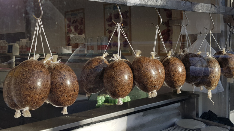 Balls of haggis hanging in a storefront window