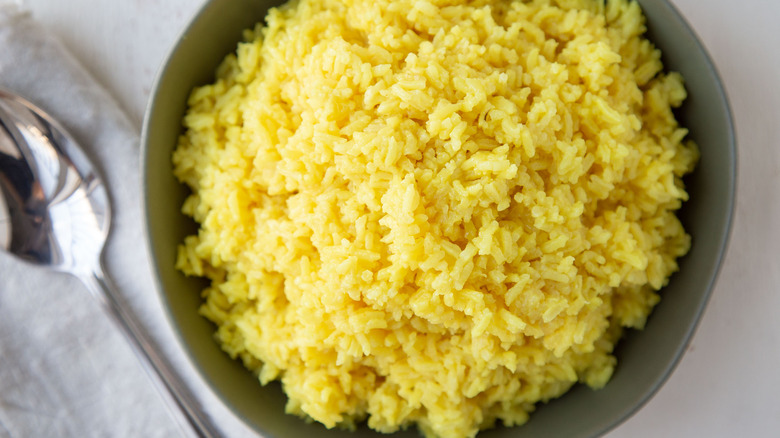 yellow rice in green bowl