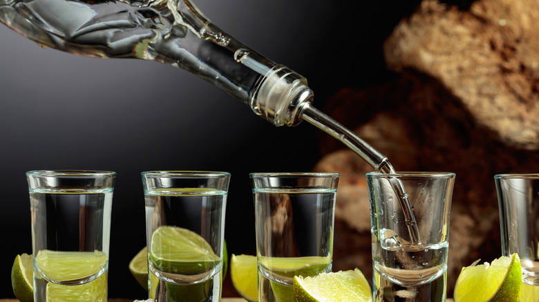 Pouring a round of shots with limes