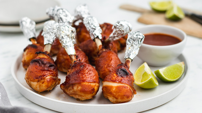 chicken lollipops with lime wedges