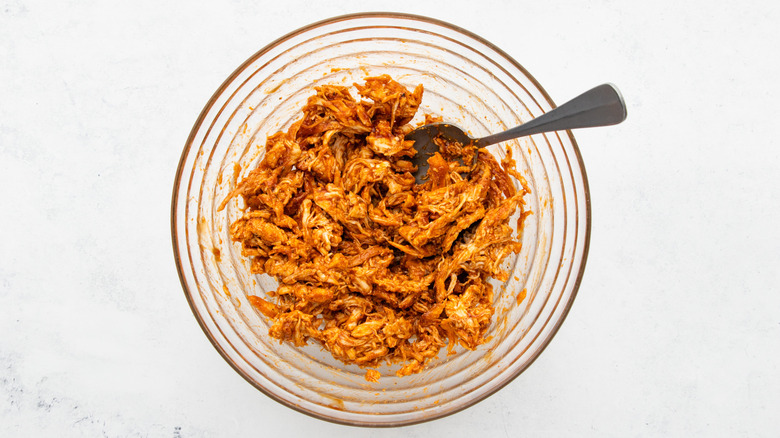 BBQ shredded chicken in mixing bowl