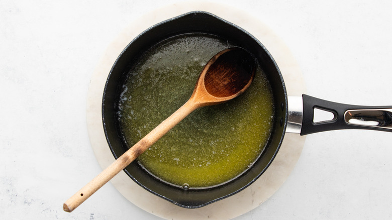 Melted butter in saucepan with wooden spoon