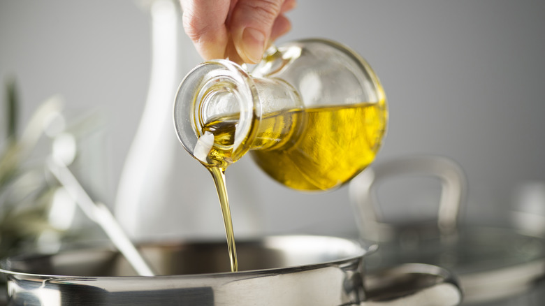 pouring olive oil in pot