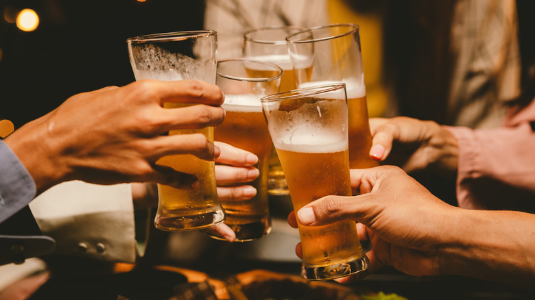 A group of friends saying cheers with beers