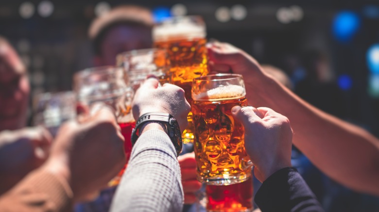 Hands toasting with beer