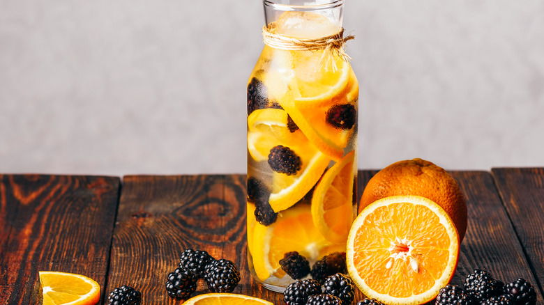 Berries and oranges in container