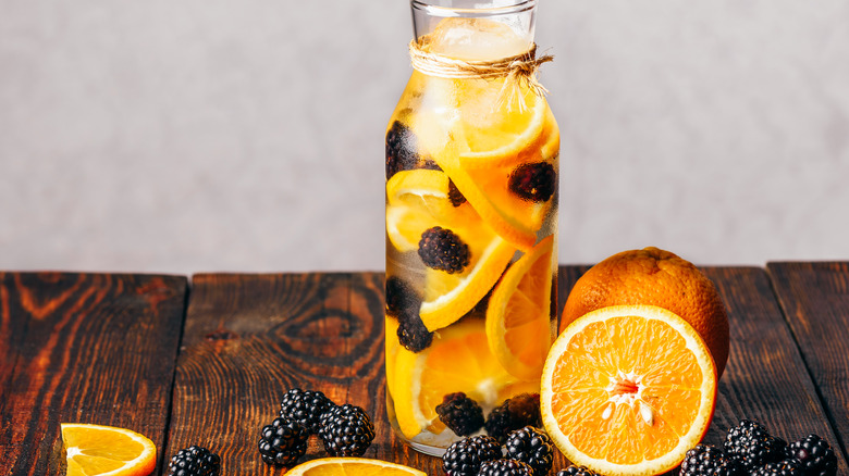 Berries and oranges in container