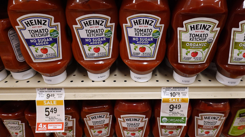 Many grocery store rows of Heinz ketchup bottles