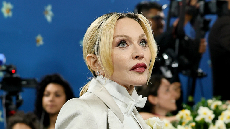 Madonna wearing a white jacket and dark lipstick