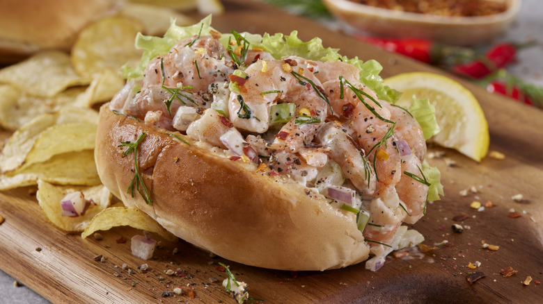 Shrimp salad sandwich with potato chips in the background﻿