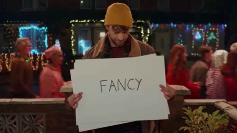 Man holding up "Fancy" sign from McDonald's commercial