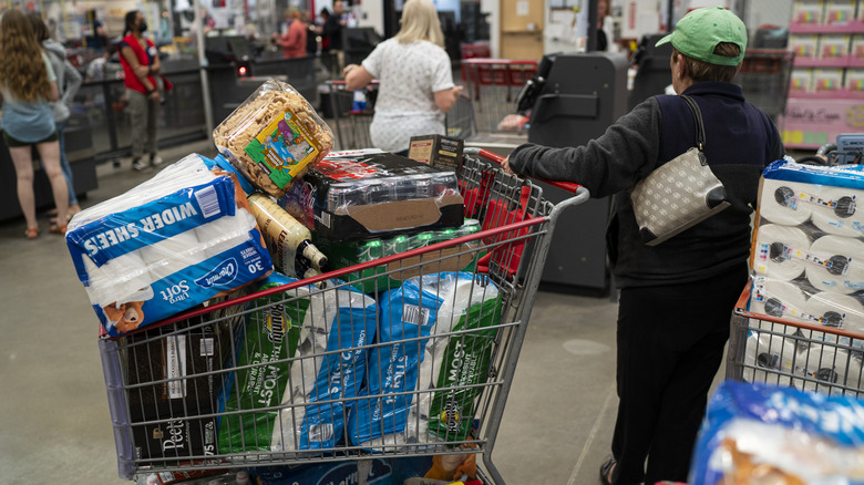 Person with loaded shopping cart