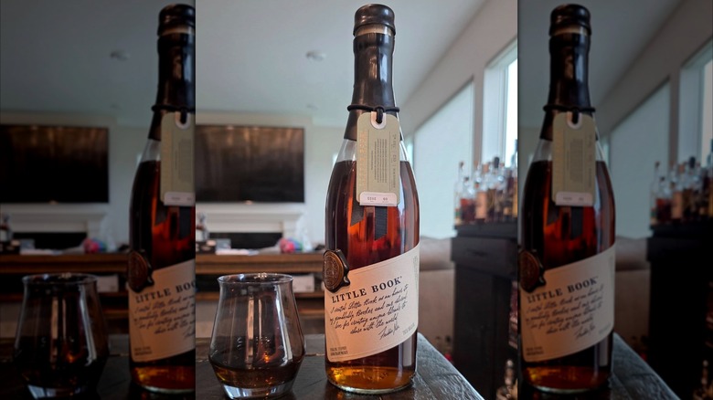 Bottle of Little Book Chapter 9 with a glass on a table