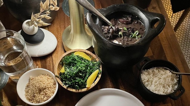 a pot of feijoada with sides