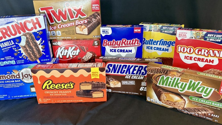 Assorted boxes of ice cream candy bars on black backdrop.