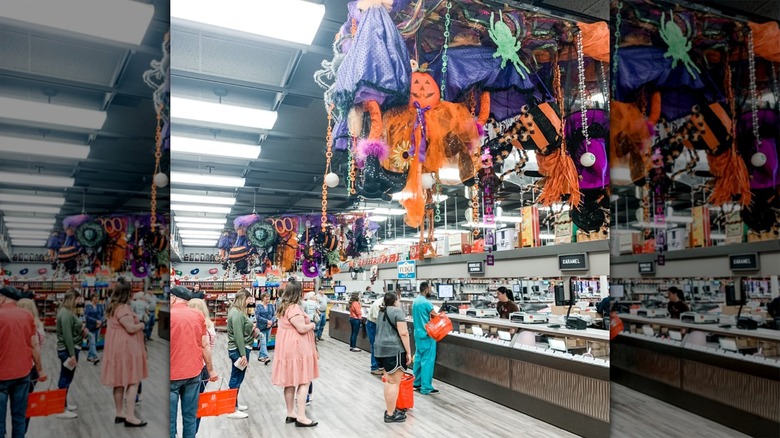 Guests line up in front of counter at Nifty Nut House, decorated for Halloween