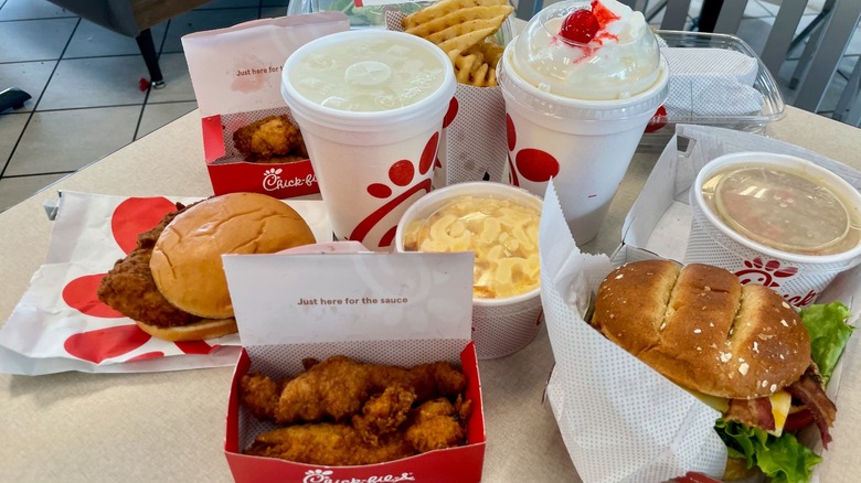 An assortment of food from Chick-fil-A spread out on table