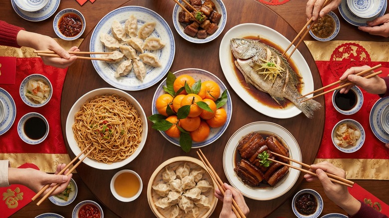people enjoying a large Chinese meal
