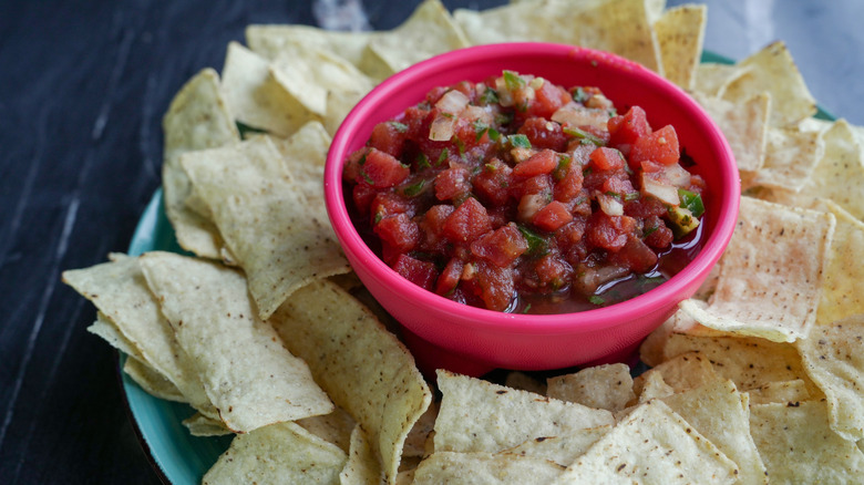 A plate of tortilla chips and salsa