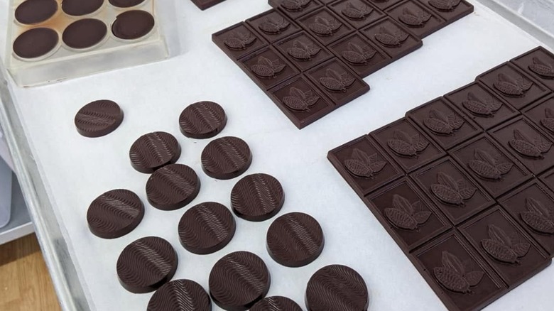 Array of molded chocolate medallions.