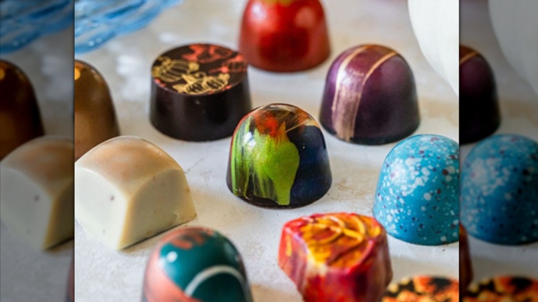 Display of colorful hand painted chocolates.