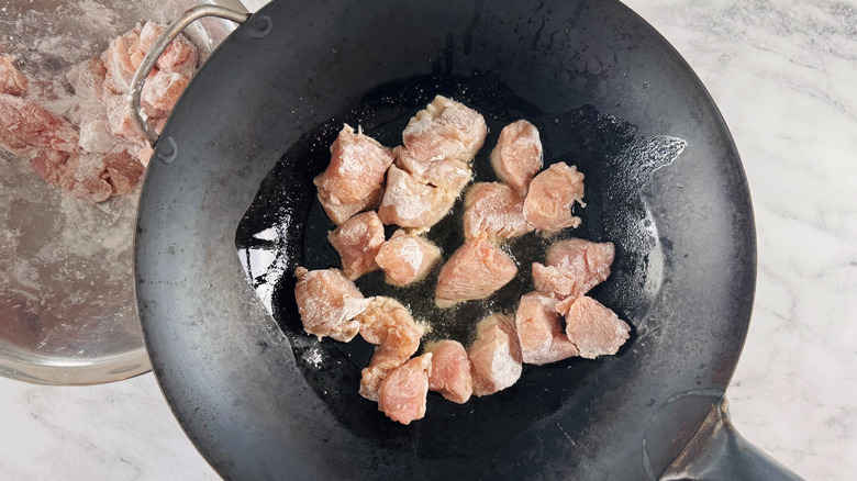 Chicken pieces in wok