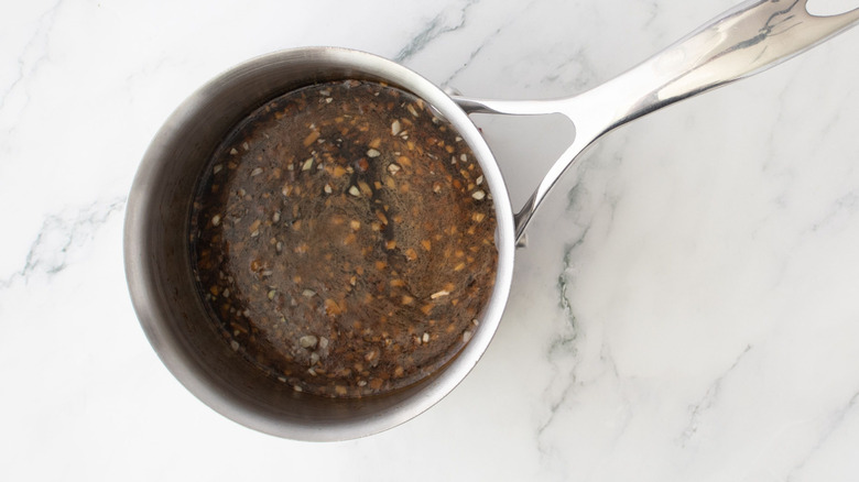 Teriyaki sauce in a saucepan on marble surface