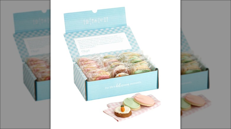Blue box of cookies decorated with Easter colors and designs.