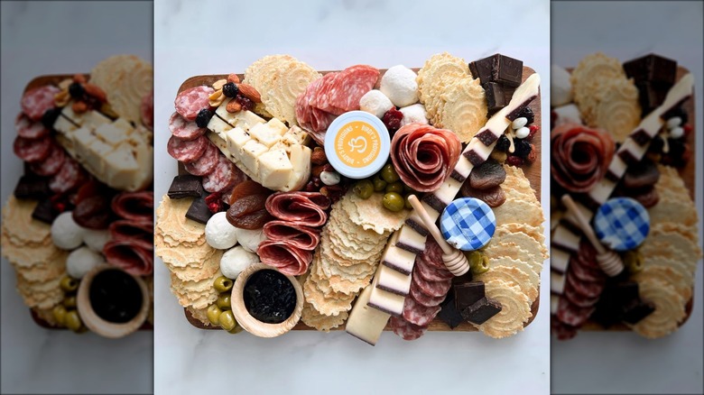 Charcuterie spread with meats, cheeses, crackers, condiments, and more.