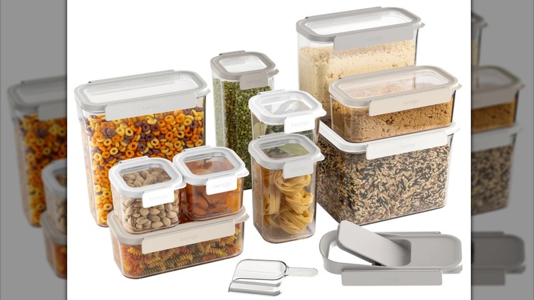 Assorted storage containers with cereal, pasta, nuts, and other foods