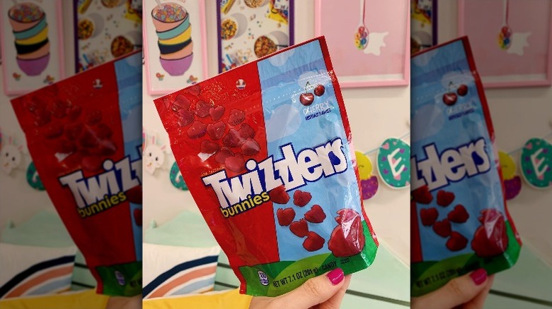 holding bag of Twizzler cherry bunnies candy