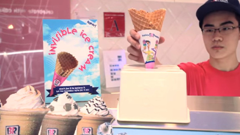 server serving Baskin Robbins invisible ice cream cone
