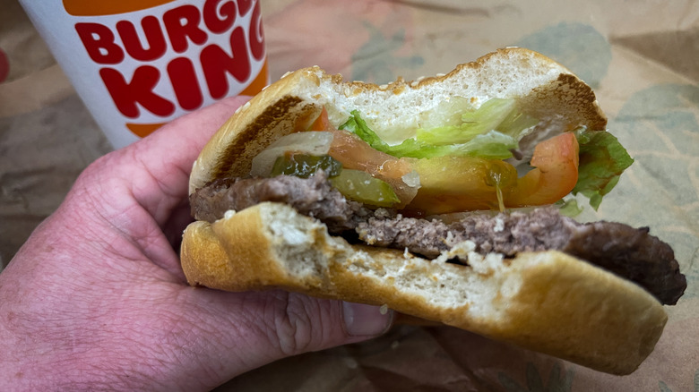 Left handed customer holding Whopper