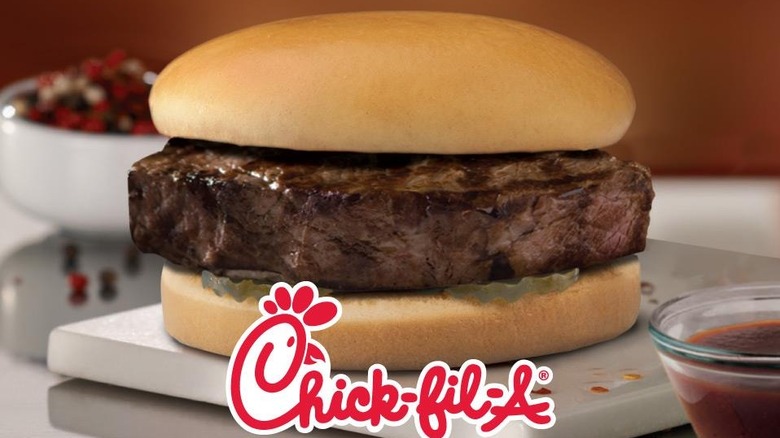 Chick Fil A steak sandwich sitting on white plate