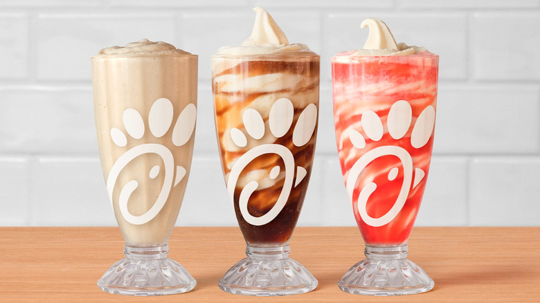 Chick-fil-A's frosted soda and float in clear glasses with the brand's logo.