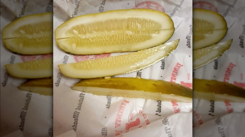 Closeup of a dill pickle in a Jimmy John's wrapper