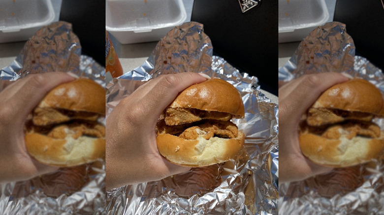 Hand holding a fish sandwich from Barbera's Seafood in NJ