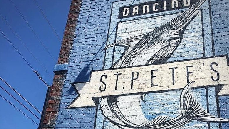 wall with st. pete's mural and marlin painted on side