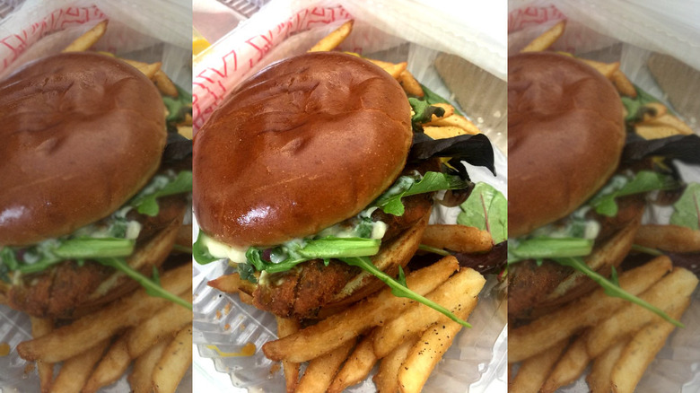 sugar's crab shack salmon sandwich in basket with fries