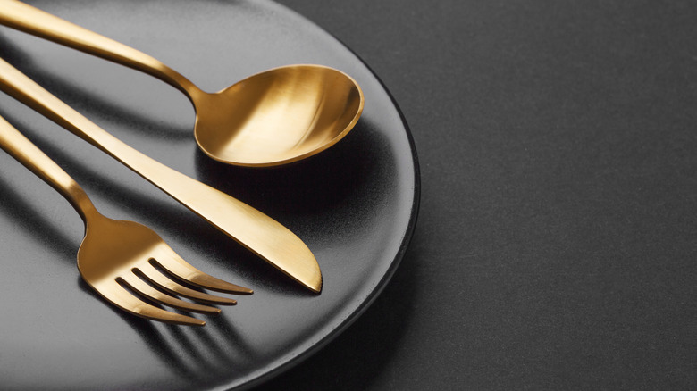 Fork, spoon, and knife on plate
