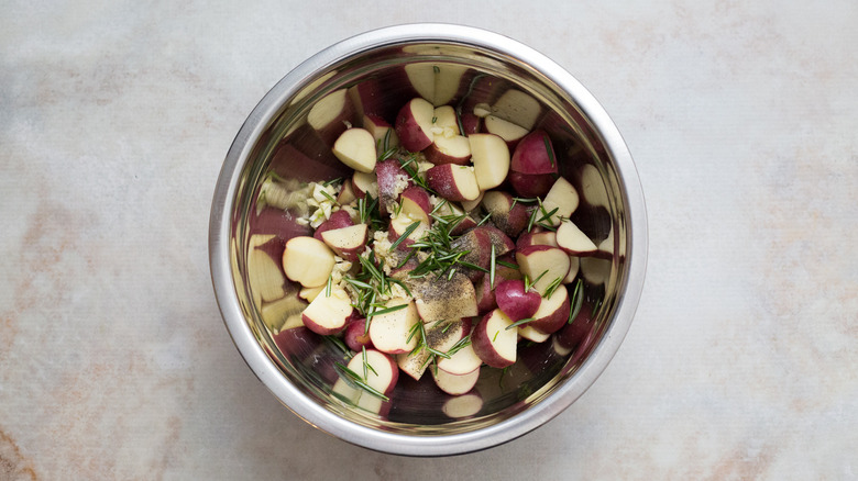 seasoned raw potatoes in bowl