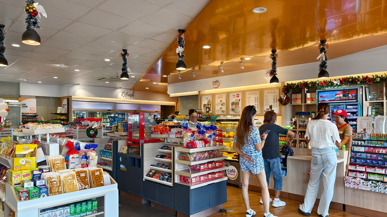 interior of a gas station with snacks, drinks, and a food counter