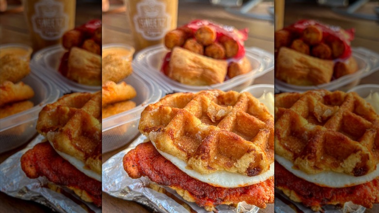 close-up photo of a waffle breakfast sandwich with egg and fried chicken