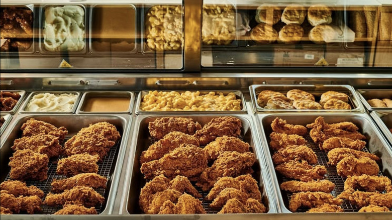 Glass case with an array of fried chicken and sides