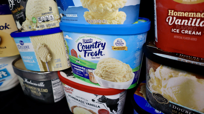 Various types of vanilla ice cream in stacked cartons
