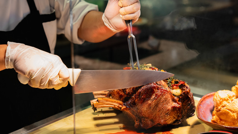 chef cutting into prime rib