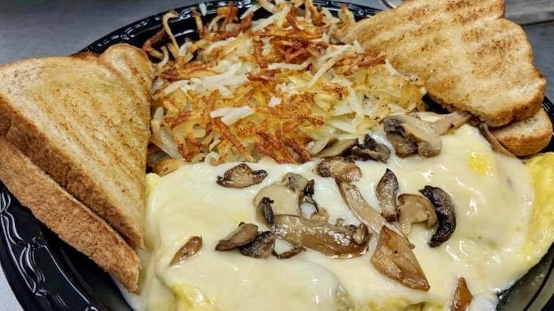 close up of hash browns, toast, and omelet